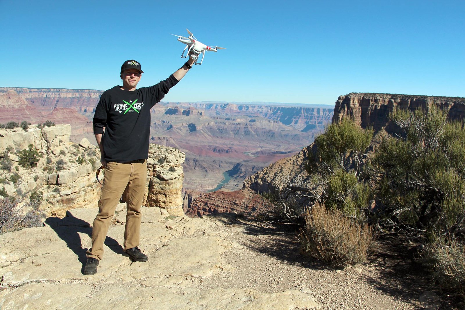 Justin Davis holding a drone at a canyon overlook