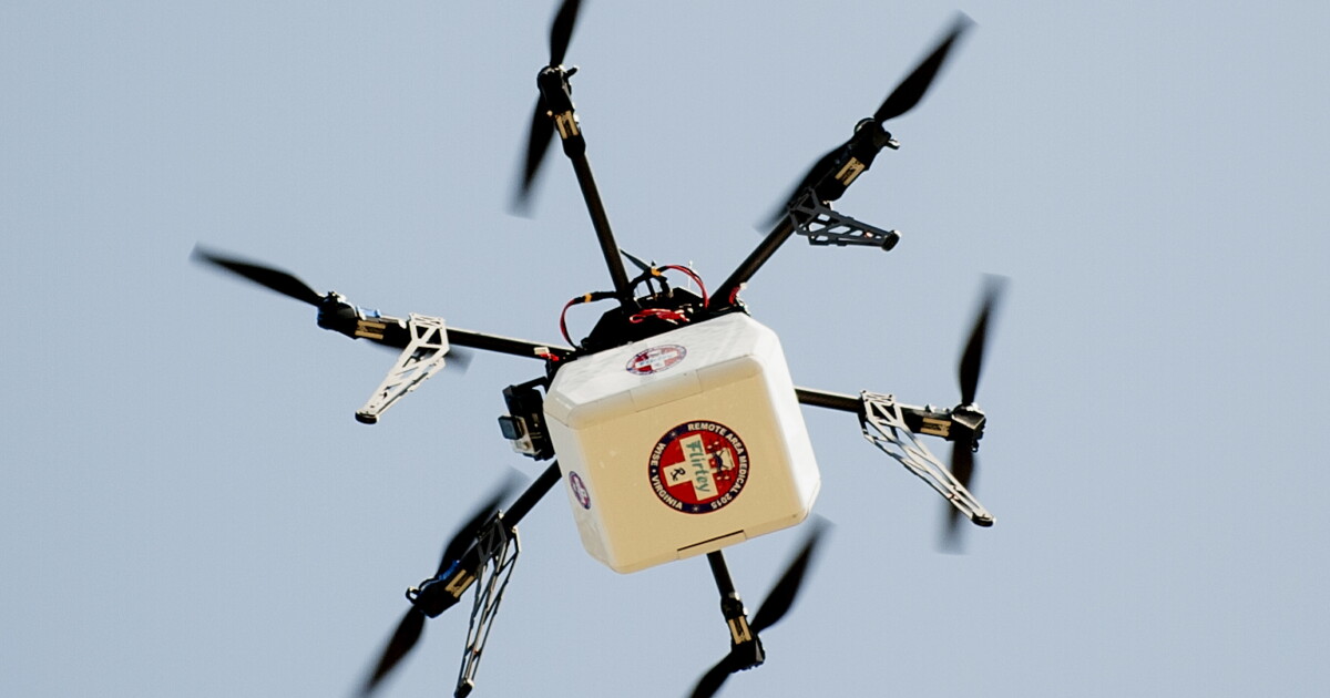 Drone carrying medical supplies over a rural area