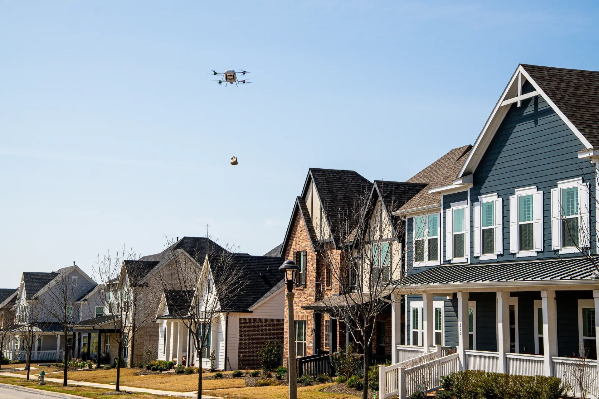 Delivery drone flying over a suburban neighborhood