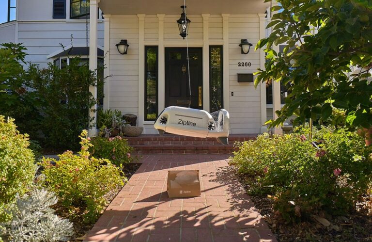 Delivery drone lowering a package on a tether